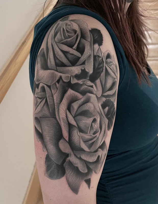 Realistic black and gray roses half sleeve tattoo.