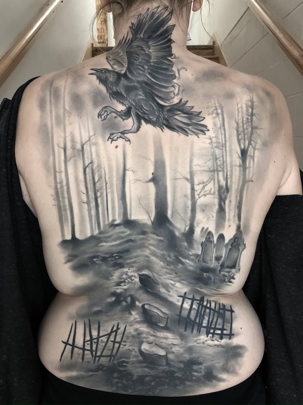 Realistic black and grey graveyard and crow flying in the air backpiece tattoo.
