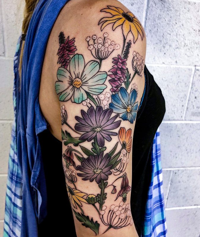 Colorful wildflower tattoo sleeve on a woman.