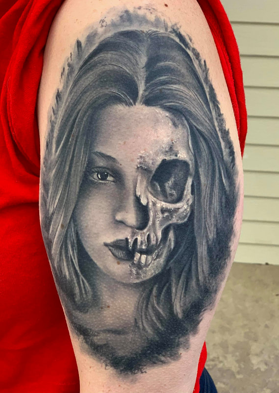 Realistic black and gray half skull half girl portrait half sleeve tattoo.