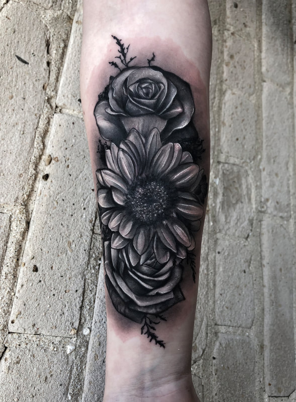 Realistic black and gray sunflower with roses forearm tattoo.