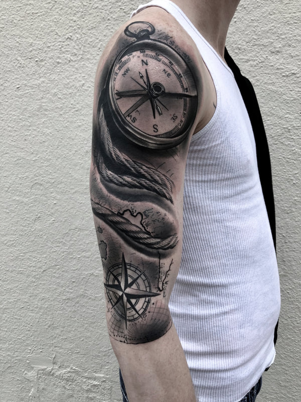 Realistic black and grey compass collage tattoo sleeve.