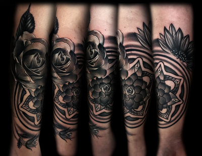 Realistic black and gray flowers and mandala forearm tattoo.