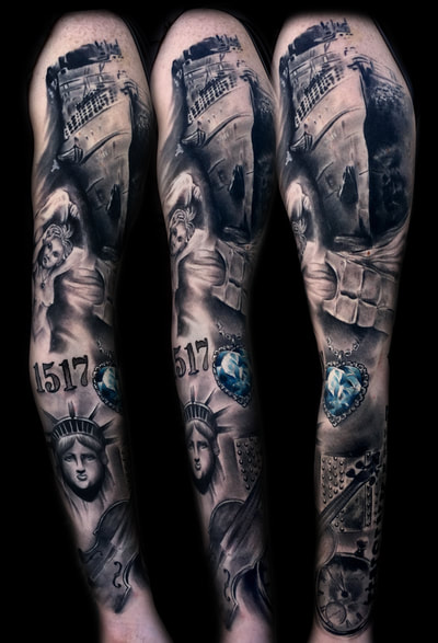 Realistic black and gray sleeve tattoo of the Titanic, Statue of Liberty, and a blue heart gem. 