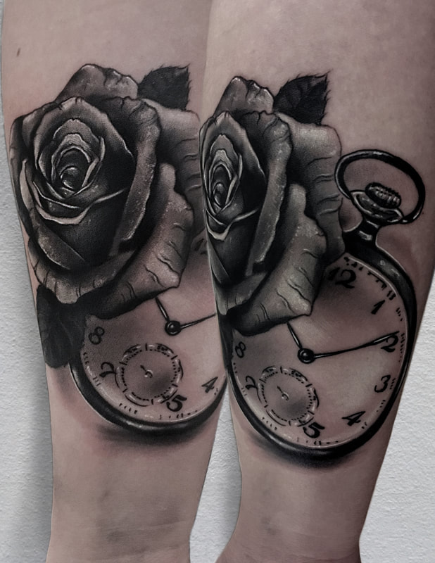 Realistic black and gray rose and pocket watch forearm tattoo.